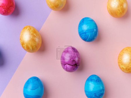 Foto de Flat lay with colored easter eggs on bright background. Creative template for festive content - Imagen libre de derechos