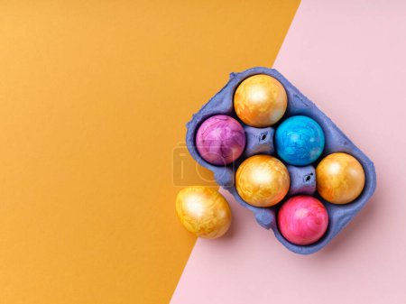 Foto de Flat lay with colored easter eggs on bright background. Creative template for festive content - Imagen libre de derechos