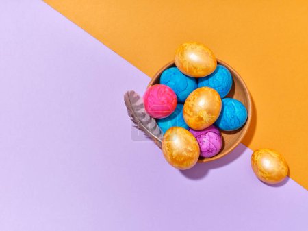 Foto de Creative layout with colored easter eggs on bright background. A template for festive content - Imagen libre de derechos
