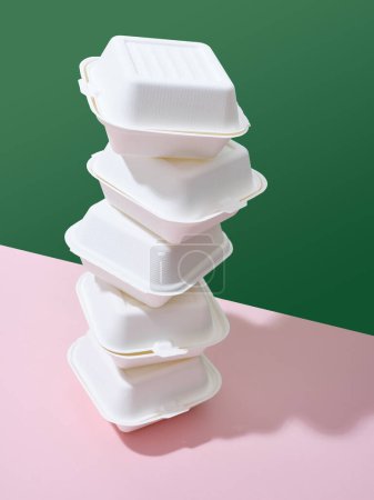 Photo for Ecological food delivery packaging. Burger takeaway boxes on green and pink background - Royalty Free Image