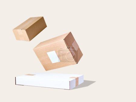 Photo for Stack of cardboard parcels floating against beige background - Royalty Free Image