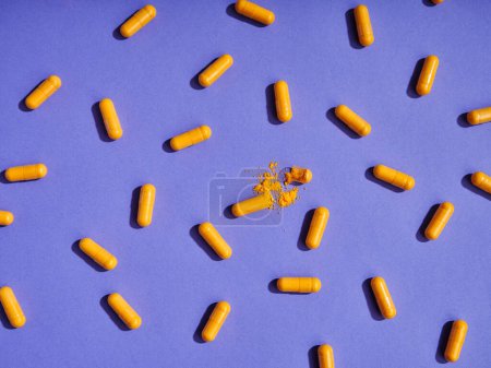 Photo for Orange pills on violet background - Royalty Free Image