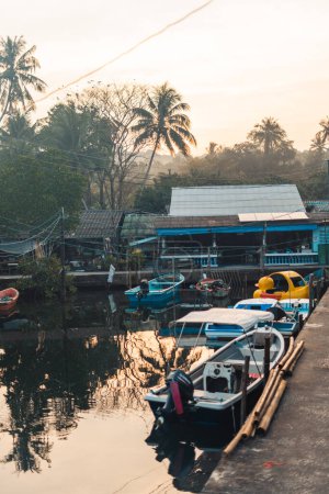 Boats in the canal at the rural pier on the island in the morning