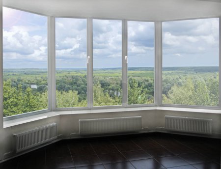 Photo for Window with view to summer landscape. Panoramic window with natural landscape in room. Beautiful landscape in bedroom. window with view to vast picturesque summer view - Royalty Free Image