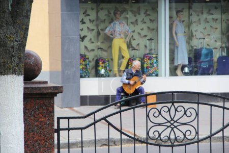 Photo for Musicians play guitar outdoors in Gomel. Guitarist earn their living by playing with guitar. Selective focus. Music outdoor. busker playing guitar outside - Royalty Free Image