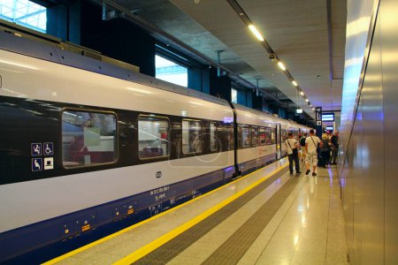 Photo for Lodz - Poland. 17 August 2019: electric train leaving station in subway in Lodz. Train leaving station. Passengers waiting train on platform. Modern transport - Royalty Free Image