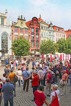Photo for Gdansk - Poland. 21 June 2019: Crowds of tourists walk in the historical part of Gdansk. Many tourists walk around Gdansk. Beautiful tourist Polish city of Gdansk. Group of Europian tourists during journey - Royalty Free Image