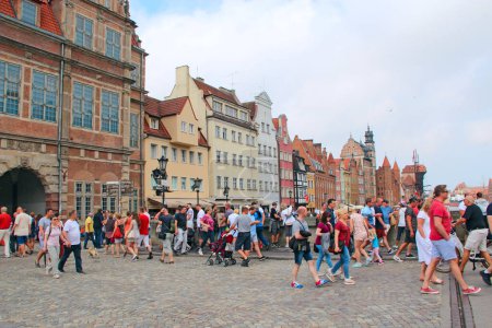 Photo for Gdansk - Poland. 21 June 2019: Crowds of tourists walk in the historical part of Gdansk. Many tourists walk around Gdansk. Beautiful tourist Polish city of Gdansk. Group of Europian tourists during journey - Royalty Free Image