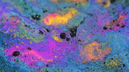 Wet dye background. Pigment fluid. Colorful swirls. Blue purple yellow black shimmering particles paint blend captivating abstract waves spreading.
