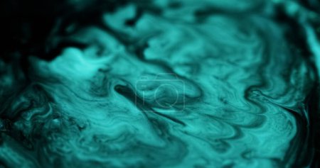 Glitter paint wave. Emulsion splash. Defocused cyan blue black color glowing particles texture liquid mix abstract art background.