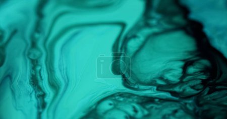 Wet marble. Ink blend. Blur cyan blue black color glowing texture liquid acrylic emulsion flow wave dark abstract art background.