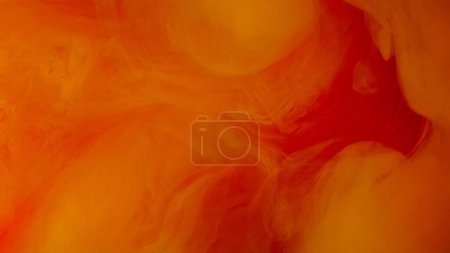 Ink water drop. Vapor cloud. Defocused orange red color shimmering glitter particles explosion smoke floating abstract art background.