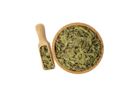 Photo for Dried leaves o Lemon verbena in latin Aloysia citrodora in wooden bowl and scoop isolated on white background. Medicinal herb. Lemon verbena leaf extract is used for its energizing and refreshing properties, lemony scent. - Royalty Free Image