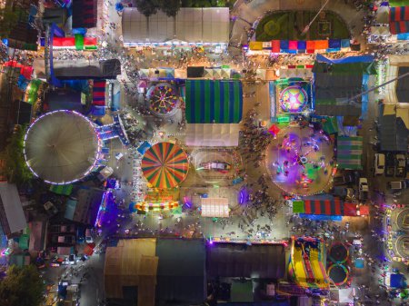 Photo for Aerial top view of amusement park in night temple fair, and night local markets. People walking street, Colorful tents in Bangkok city, Thailand. Retail shops - Royalty Free Image