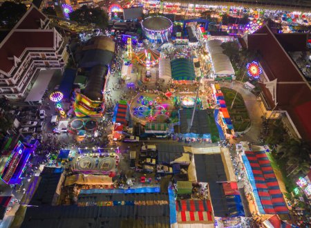 Photo for Aerial top view of amusement park in night temple fair, and night local markets. People walking street, Colorful tents in Bangkok city, Thailand. Retail shops - Royalty Free Image