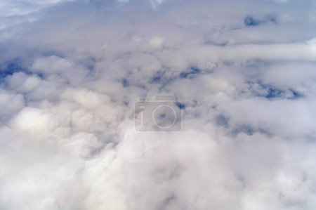 Photo for Airplane jet flying above clouds view with blue sky from the window in traveling and transportation concept. Nature landscape background. - Royalty Free Image