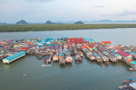 Photo for Aerial view of Koh Panyee, The Floating village urban city town houses, lake sea or river. Nature landscape fisheries and fishing tools at Pak Pha, Phang Nga, Thailand. Aquaculture farming - Royalty Free Image