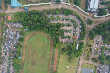 Photo for Aerial top view of soccer football sport recreation field ground, national stadium. Urban city town in Asia. Green court arena. - Royalty Free Image