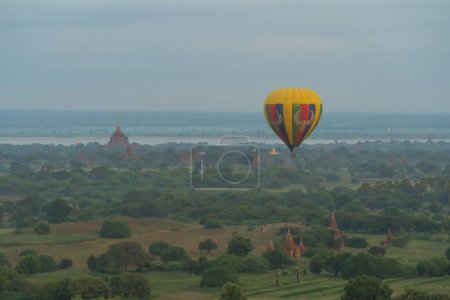 Photo for Balloons flying over Burmese temples of Bagan City from a balloon, unesco world heritage with forest trees, Myanmar or Burma. Tourist destination. - Royalty Free Image