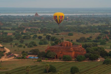 Photo for Balloons flying over Burmese temples of Bagan City from a balloon, unesco world heritage with forest trees, Myanmar or Burma. Tourist destination. - Royalty Free Image