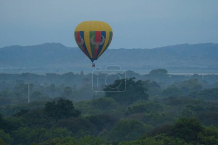 Téléchargez les photos : Des ballons survolant les temples birmans de la ville de Bagan depuis un ballon, patrimoine mondial de l'Unesco avec des arbres forestiers, le Myanmar ou la Birmanie. Destination touristique. - en image libre de droit