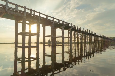 Photo for U Bein Bridge with lake, Wooden Bridge in Mon village, Myanmar or Burma, Asia. - Royalty Free Image