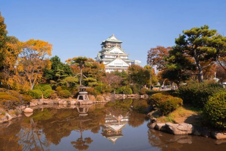 Photo for Osaka Castle building with colorful maple leaves or fall foliage in autumn season. Colorful trees, Osaka City, Japan. Architecture landscape background. Famous tourist attraction. - Royalty Free Image