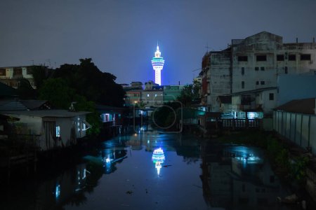 Samut Prakan Observation Tower with river reflection in urban city town, Thailand.