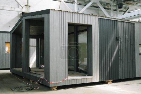 A new wooden modular prefabricated house inside an industrial building.