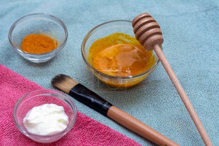 Photo for Homemade face mask with turmeric, yoghurt, coconut oil and honey for uneven skin tone, brightening dark spots and reducing fine wrinkles in diy beauty - Royalty Free Image