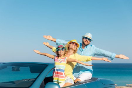 Photo for Happy family travel by car at the sea. Mother, father and daughter having fun in blue cabriolet. Summer vacation concept - Royalty Free Image