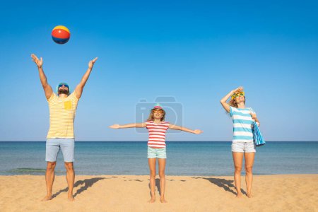 Photo for Happy family on summer vacation. Mother, father and child on the beach. People having fun by te sea - Royalty Free Image