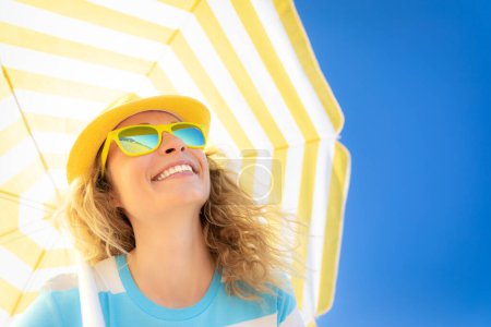 Téléchargez les photos : Belle femme en vacances d'été. Vue à angle bas portrait de la personne heureuse sur fond de ciel bleu. - en image libre de droit