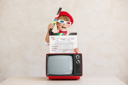 Photo for Director shouting against grunge wall background. Boy playing in home. Child wearing vintage costume. Kid holding clapper. Social media and Internet nerwork concept - Royalty Free Image
