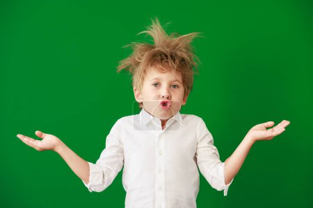 Photo for Surprised child in class. Funny kid against green chalkboard background. Back to school and education concept - Royalty Free Image