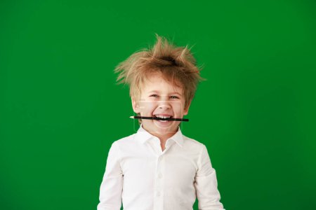 Photo for Happy child in class. Funny kid against green chalkboard background. Back to school and education concept - Royalty Free Image