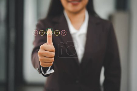 Photo for Close-up of a businesswoman's hand giving a thumbs up with digital feedback icons, indicating excellent service or satisfaction. - Royalty Free Image