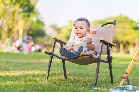 Photo for Cute little kid boy play outdoor in the park, Cheerful child boy playing in the garden - Royalty Free Image