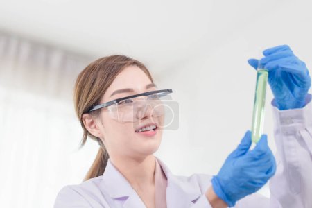 Photo for Female researcher, doctor, scientist or laboratory assistant working with medical tubes in medical science laboratory - Royalty Free Image