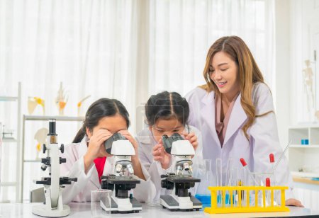 Photo for Elementary science class, Cheerful little kids and teacher scientist with chemistry liquid in school laboratory, Science laboratory - Royalty Free Image