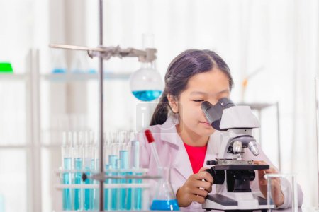 Photo for Elementary science class, Cheerful kid girl in school laboratory, Science laboratory - Royalty Free Image