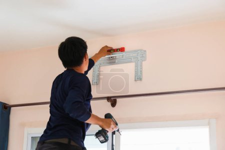 Electrician installing air conditioner unit, Repairman fixing air conditioning, Technician man installing an air conditioner unit in a client house, Maintenance and repairing concepts
