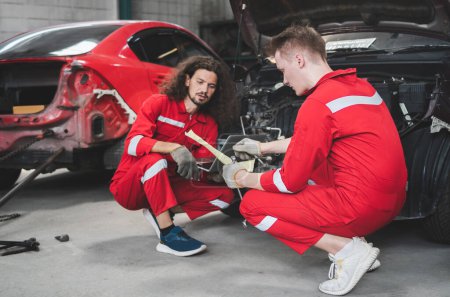Photo for Young Caucasian car mechanic with a checklist, Mechanics in uniform are working in auto service, Technician checking modern car at garage, Car repair and maintenance concepts - Royalty Free Image