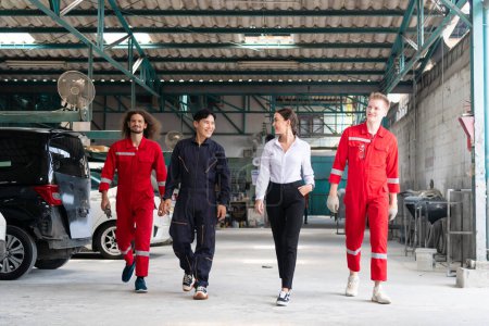 Photo for Young confident managers and car mechanics team in uniform are working in auto service. Car repair and maintenance concepts - Royalty Free Image