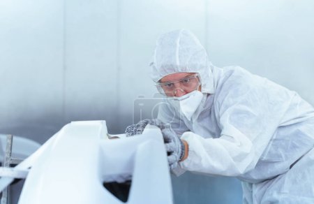 Photo for The mechanic man painting car in chamber, Technician checking the quality of the painting, Garage painting car service repair and maintenance - Royalty Free Image