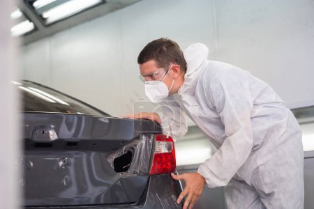 Photo for Mechanic man painting car in chamber, Technician checking the quality of the painting, Garage painting car service repair and maintenance - Royalty Free Image