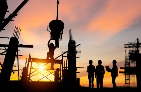 Photo for Silhouette of Engineer and worker team checking project at building site background, construction site with sunset in evening time background - Royalty Free Image