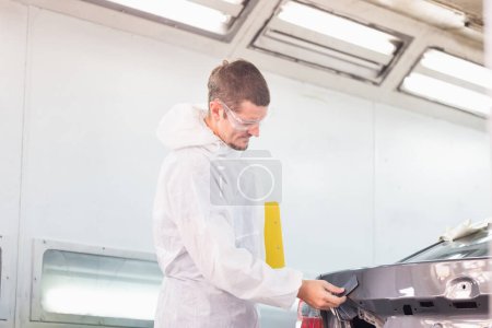 Photo for Repairman checking shades cards for car painting, Worker painter checking color matching before painting, Garage painting car service repair and maintenance - Royalty Free Image