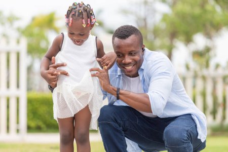 Photo for Cheerful African American father and daughter playing outdoor - Royalty Free Image
