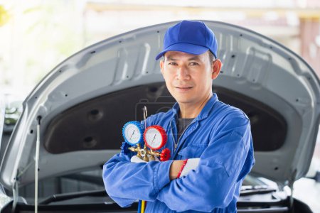 Photo for Car Air Conditioning Repair, Repairman holding monitor tool to check and fixed car air conditioner system, Technician check car air conditioning system refrigerant recharge - Royalty Free Image